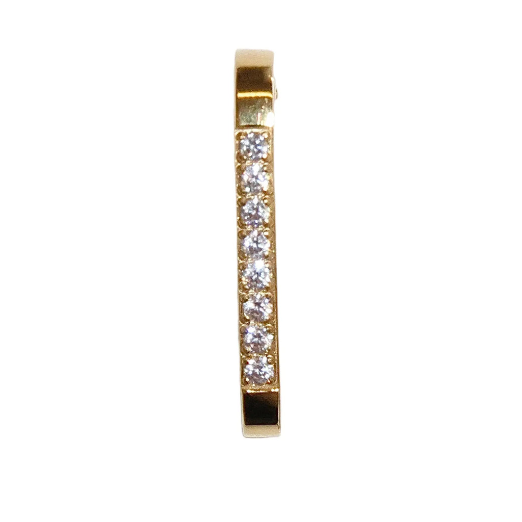 Gold earring with embedded diamonds on a white background